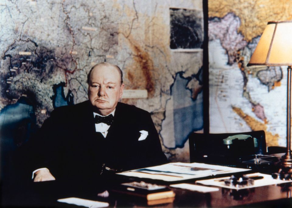  Winston Chrchill seated at his desk in the No 10 Annexe Map Room, May 1945