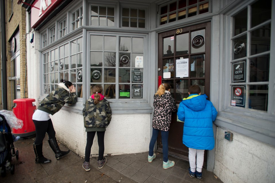  Hungry chicken-lovers look through the windows of a shut KFC shop in Hampton Hill last year