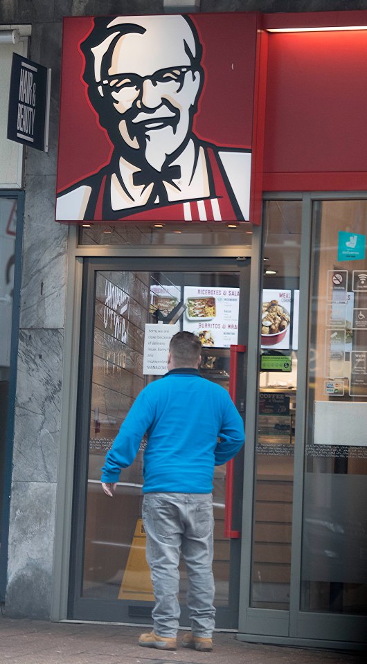  A disappointed KFC customer reads the shut notice on the door of the chain's Redhill branch