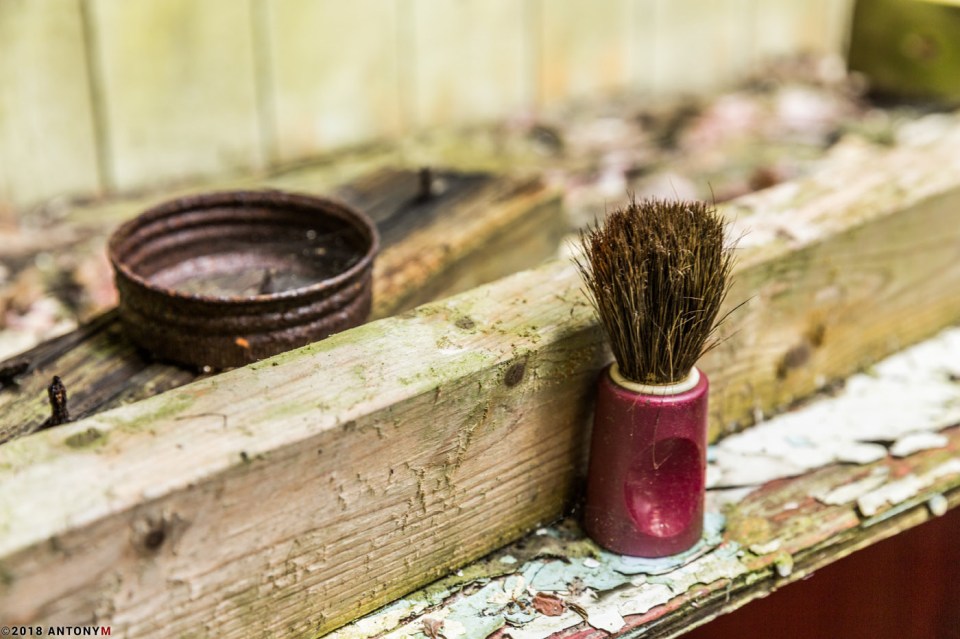 A barber's tools left on the rotting counter