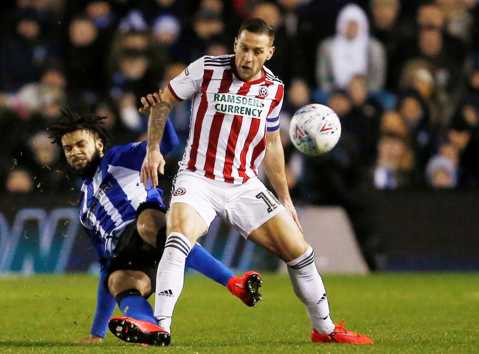  Michael Hector slides in as Sheffield United frontman Billy Sharp shields the ball