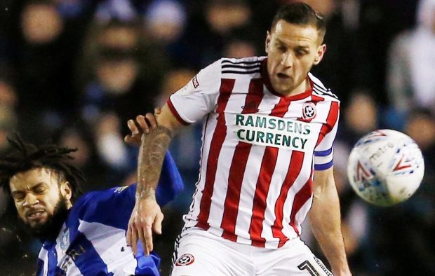 Michael Hector slides in as Sheffield United frontman Billy Sharp shields the ball