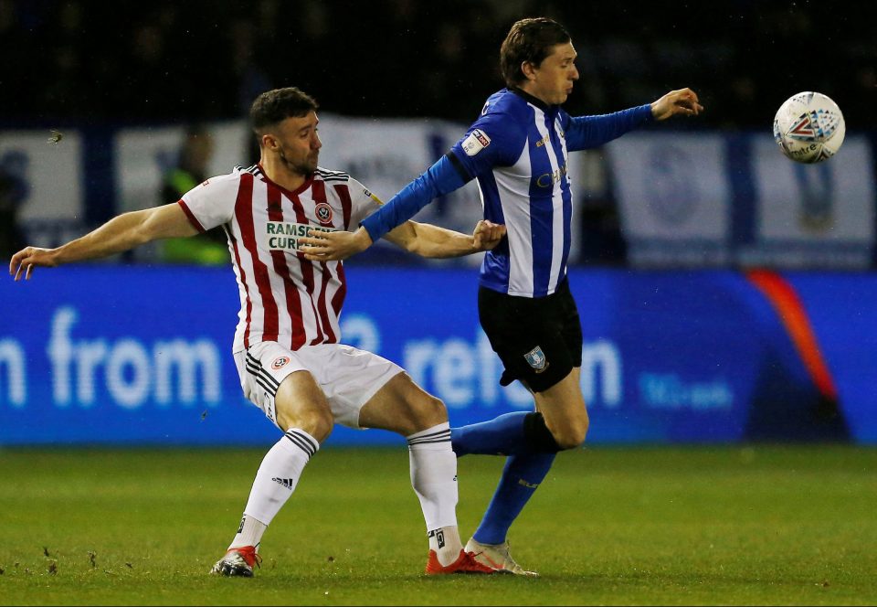  Sheffield United left-back Enda Stevens shadows Adam Reach during the derby