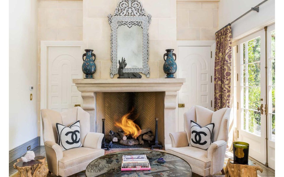  This second living room comes complete with fireplace and Chanel cushions