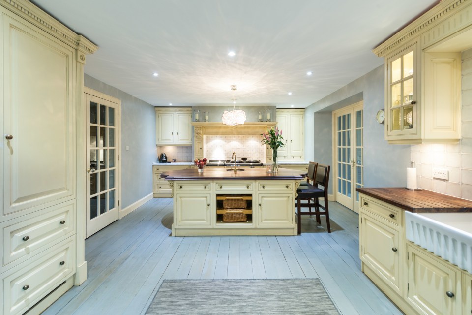  The main house's huge kitchen is decorated in stylish cream