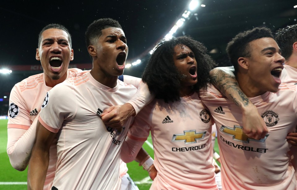 Marcus Rashford is mobbed by his United team-mates after slamming home the stoppage time penalty against PSG