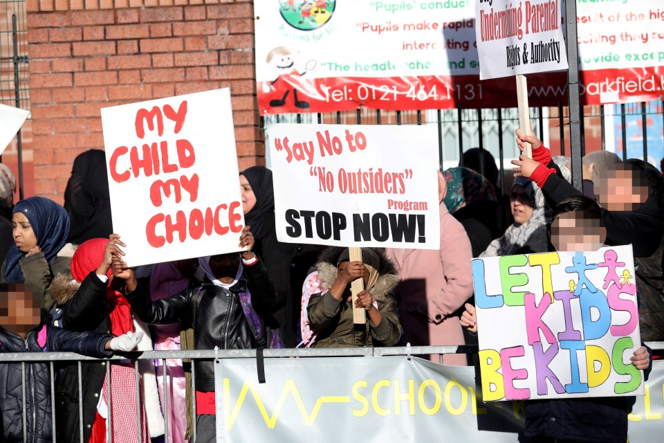  Children were holding signs outside of Parkfield Community School