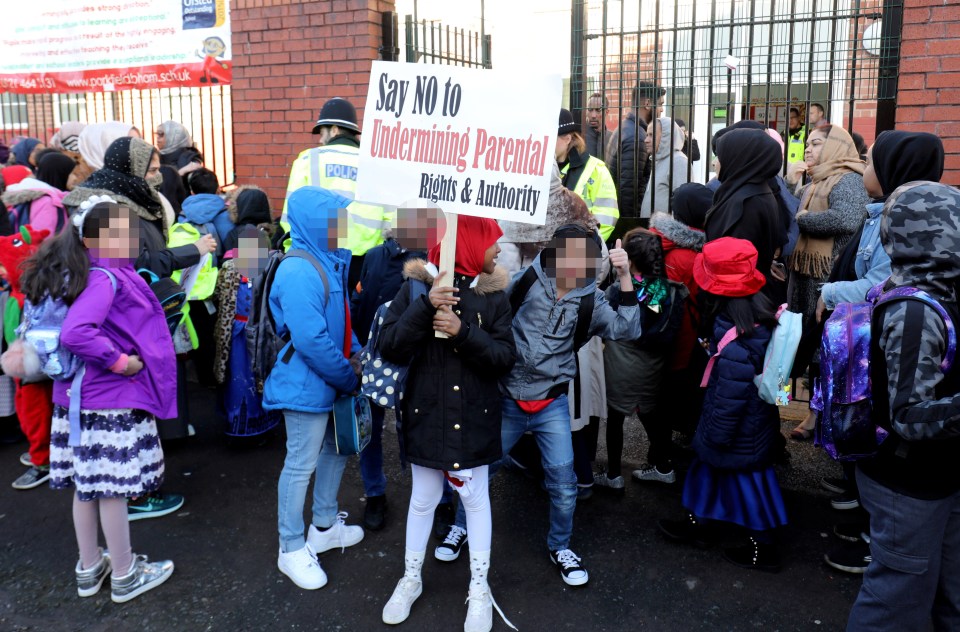  Children were seen holding signs and chanting 'shame, shame, shame' outside the primary school where the assistant headteacher introduced LGBT lessons