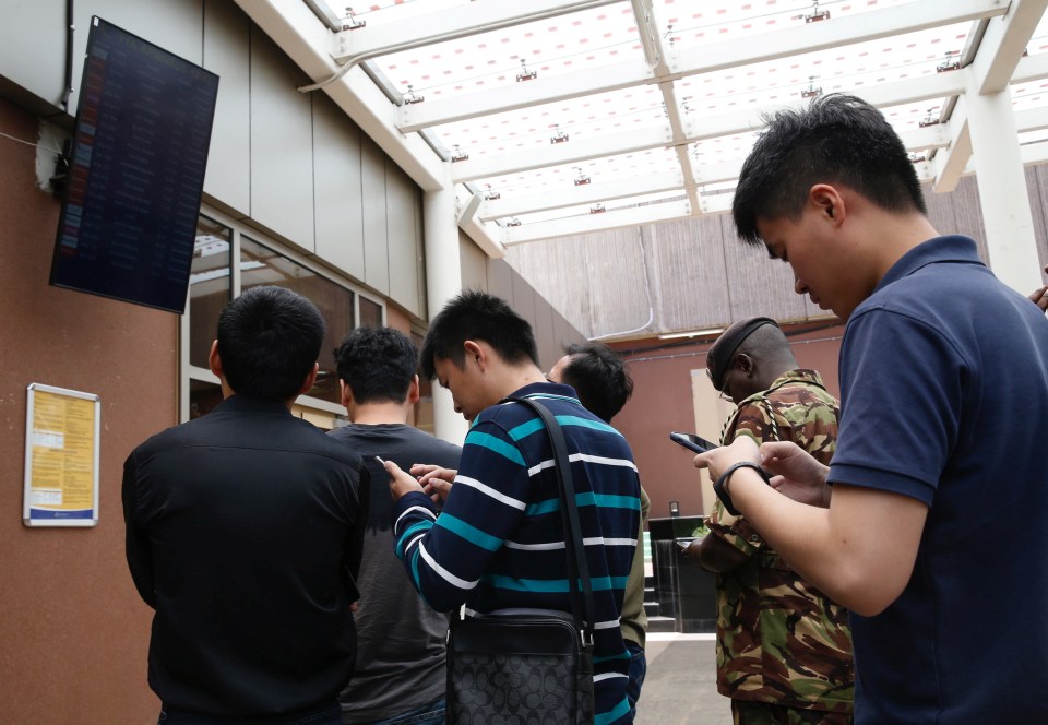 People wait for news on the crashed plane in Nairobi