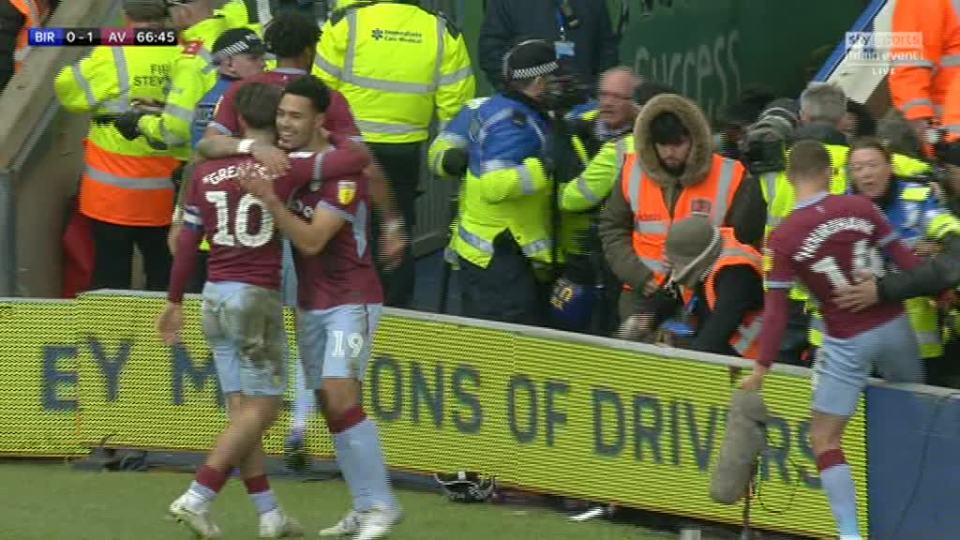 A steward is seen being hauled out of St Andrews by police after appearing to knee Jack Grealish