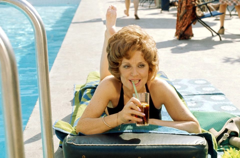  Glamorous Barbara sips a cocktail by the pool