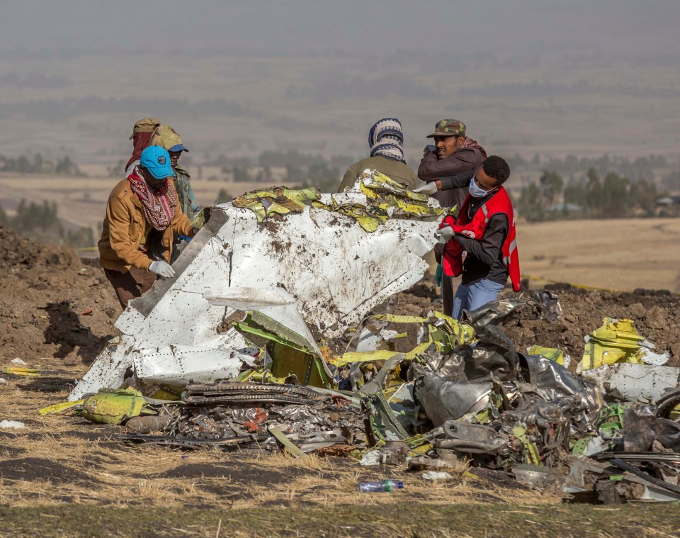  Workers collect wreckage from the Ethiopia Airlines jet that crashed