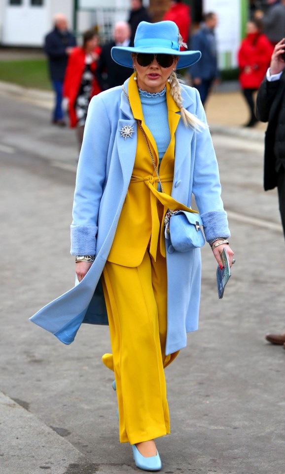  A colourful reveller ensured all eyes were on her with a bold yellow ensemble and stunning baby blue coat and hat