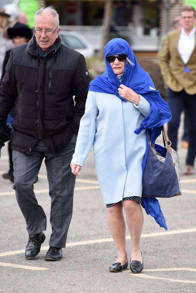  This less-than-amused lady decided to keep her hair under wraps and escape the winds by wrapping her shawl over her head for protection