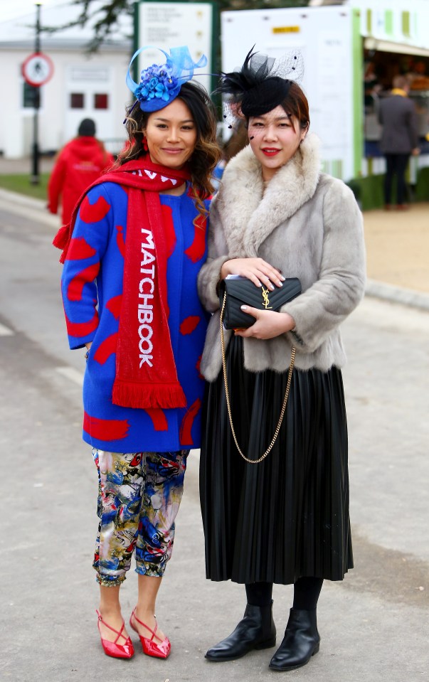  Instead of sky-high heels and figure-hugging dresses, these two women looked snug as they watched the races