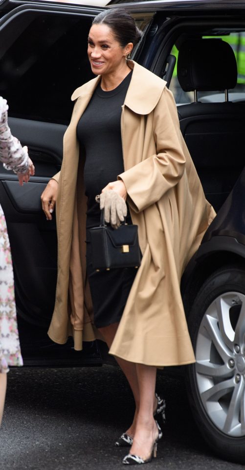  The Duchess of Sussex wears Oscar De La Renta coat with Hatch maternity dress and shoes by Gianvito Rossi on a visit to Smart Works