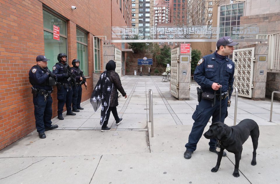  Security officials stand guard near the Islamic Cultural Center in New York