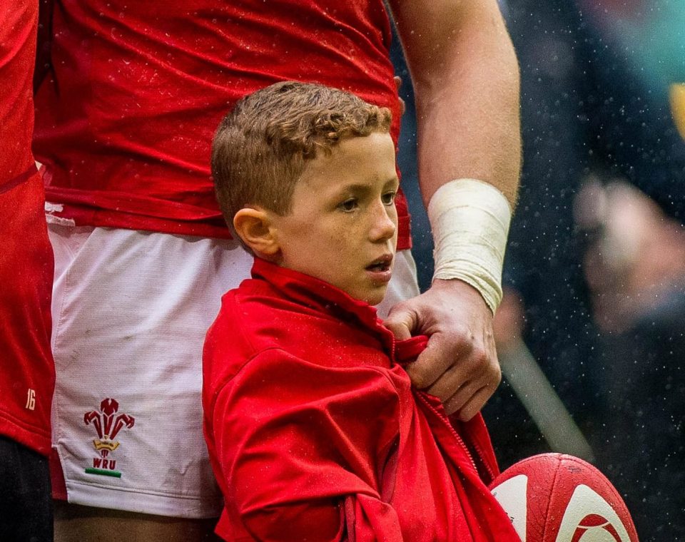  Young mascot Joey Hobbs was wrapped up in Alun Wyn Jones' jacket to keep the young lad warm