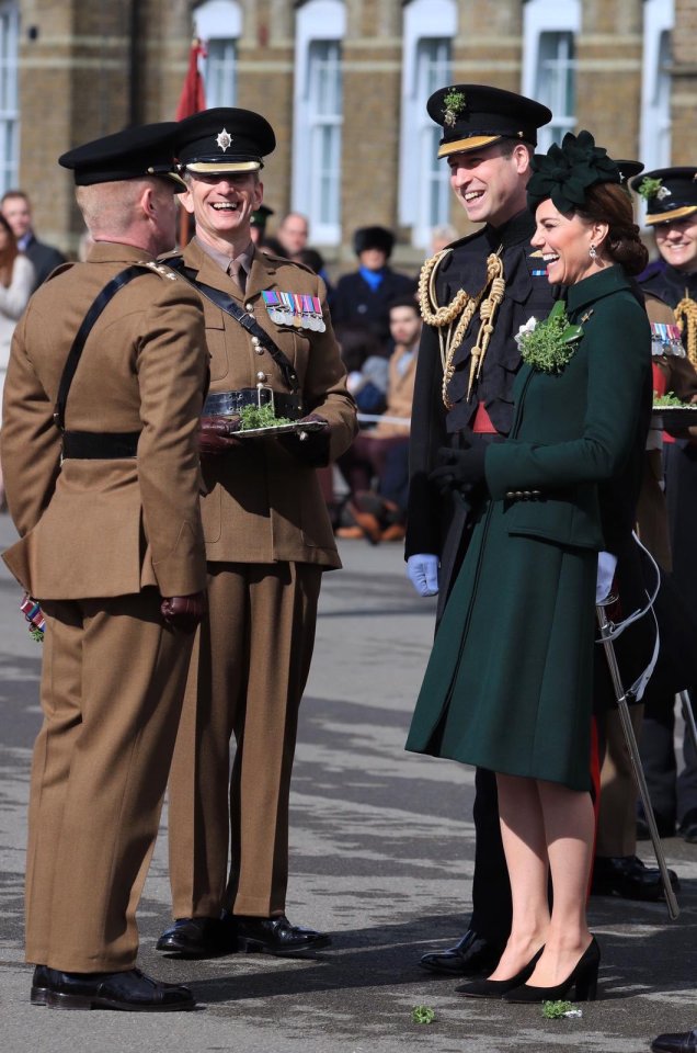  The Duke and Duchess of Cambridge laugh as they speak with officers