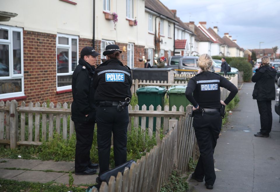  Police in Viola Avenue in Surrey where they are investigating a stabbing in which a man rampaged with a baseball bat and knife while hurling racist abuse