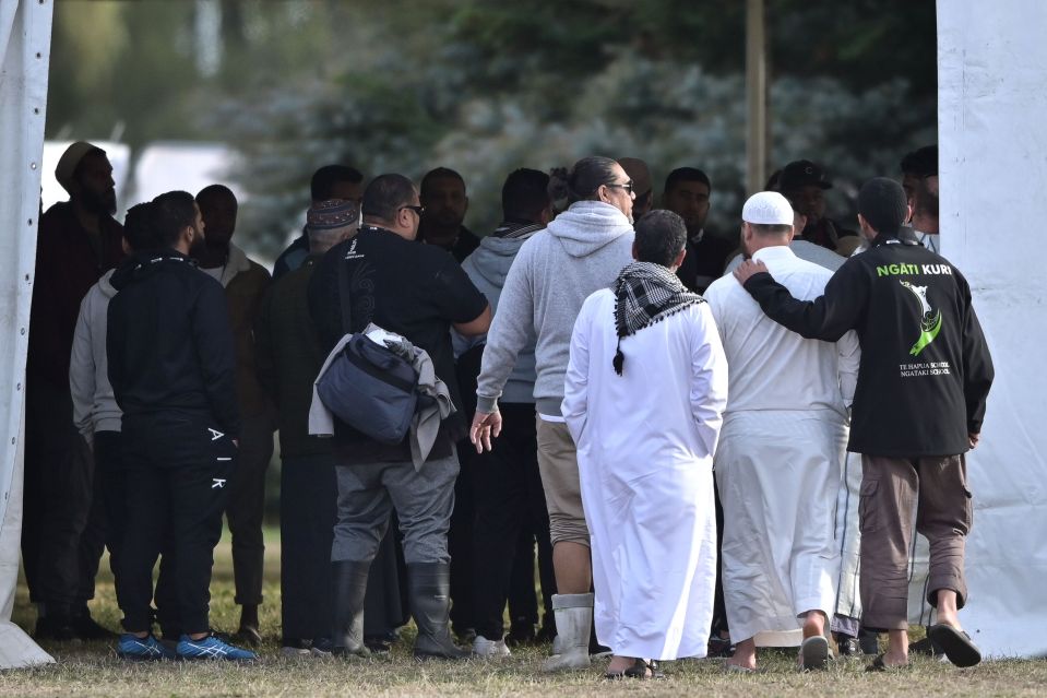  Mourners watch on as the funeral service takes place in Christchurch on Wednesday morning