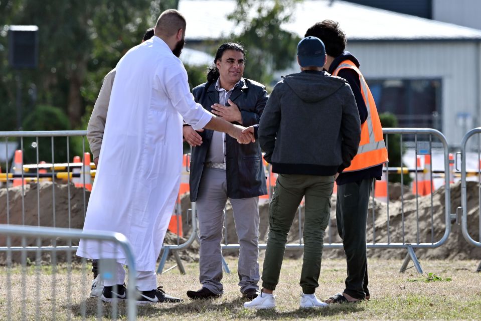  Mourners are greeted by organisers at the funeral in Christchurch - the first to take place since the atrocity on Friday