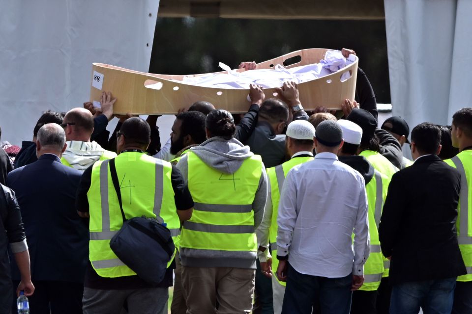  The body of one of the Christchurch terror attack victims, wrapped in a traditional white shroud, is carried by mourners in Christchurch, New Zealand