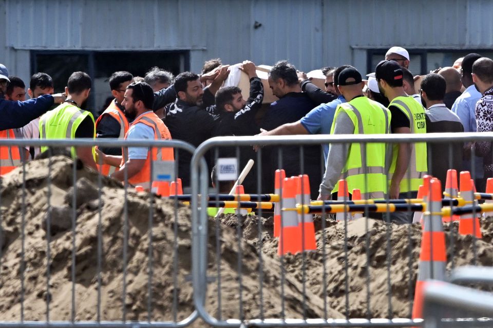  The body of one of the victims is carried by grieving mourners. As many as 50 were killed and another 50 injured in the terror attack in Christchurch