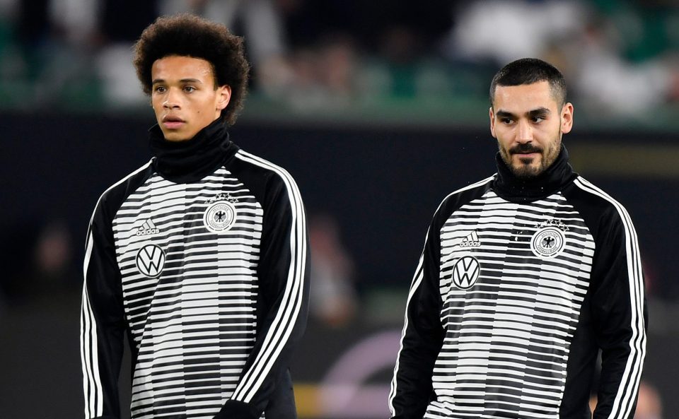  Three men have handed themselves in to police after allegedly racially abusing Leroy Sane, left, and Ilkay Gundogan, right, on Wednesday