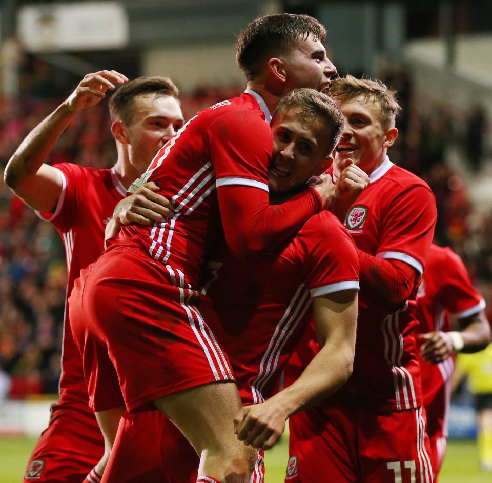  Wales mob Ben Woodburn after he headed a close-range winner at Wrexham