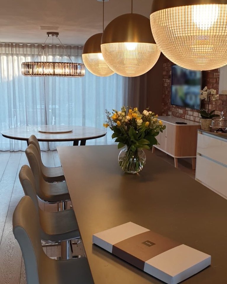  The kitchen and dining room have stunning light fixtures