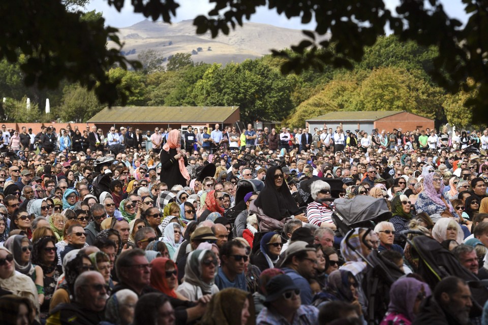 Members of the public look on during a gathering for congregational Friday prayers and two minutes of silence