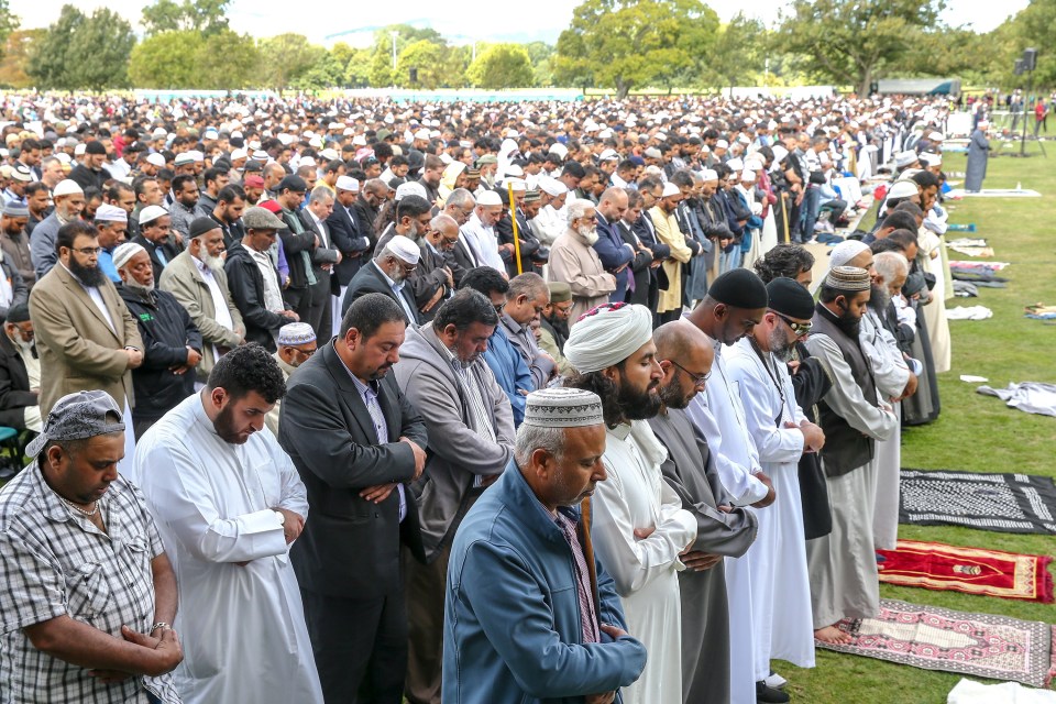 People attend a prayer at Hagley Park, opposite the Al Noor Mosque