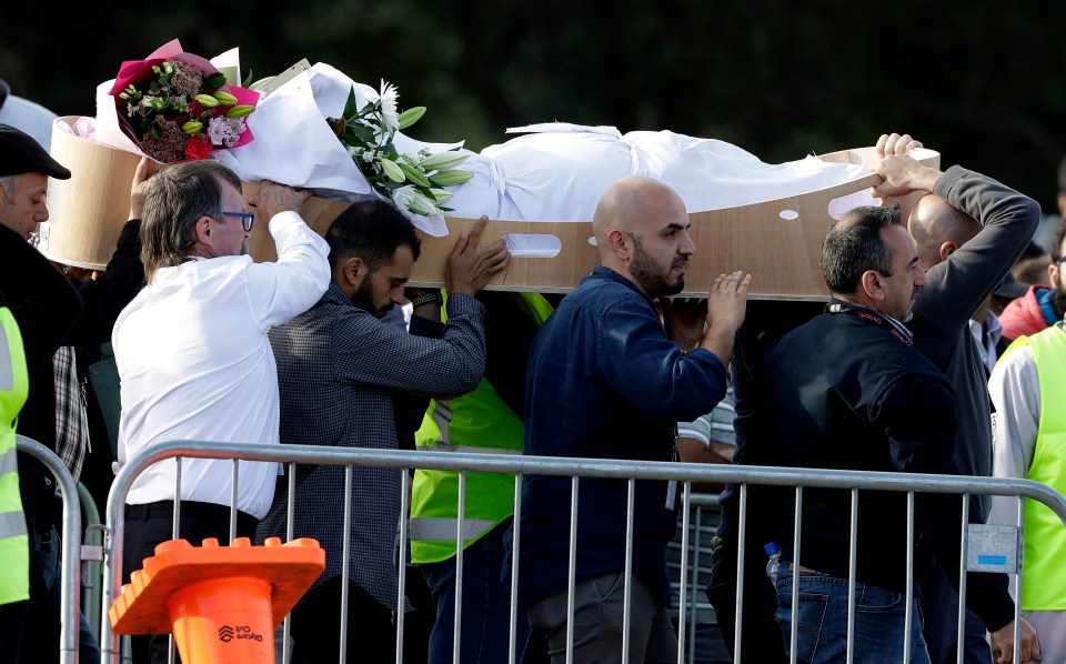  Mourners carry a body at Memorial Park Cemetery in Christchurch, New Zealand, Friday, March 22