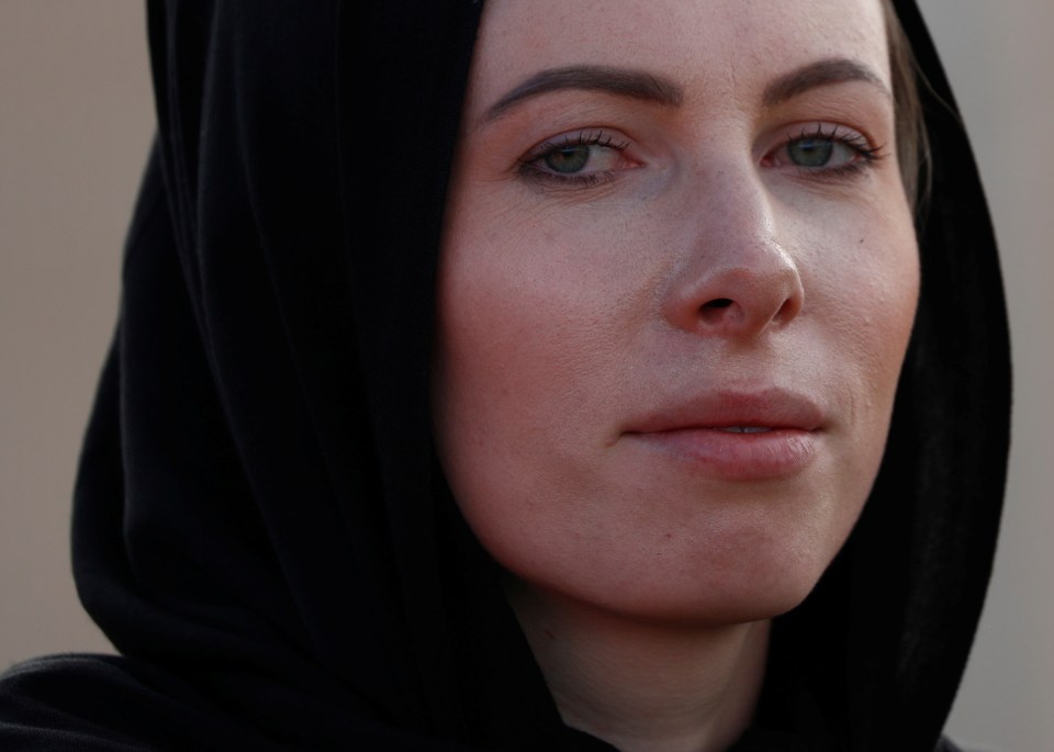  A policewoman wearing a headscarf as tribute to the victims of the mosque attacks is seen at Memorial Park Cemetery in Christchurch