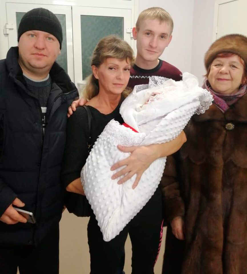  Pictured: Second from left, Svetlana Cheshko holds her newborn granddaughter Anna alongside the girl's father, Nikolay Tepikin, who stands next to Lyudmila, Alisa's grandmother