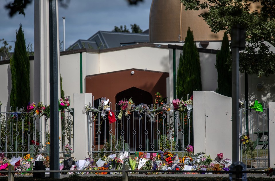 Flowers are laid on and around the fence of Al Noor mosque