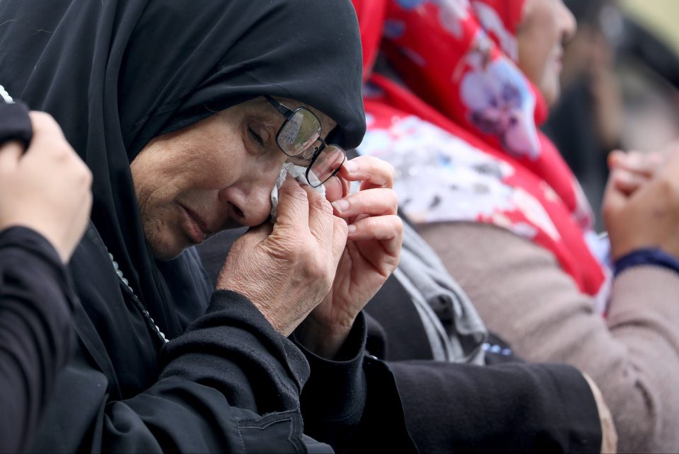  A Muslim woman weeps as she attends Friday Islamic prayers in Hagley Park outside the Masjid Al Noor mosque, Christchurch