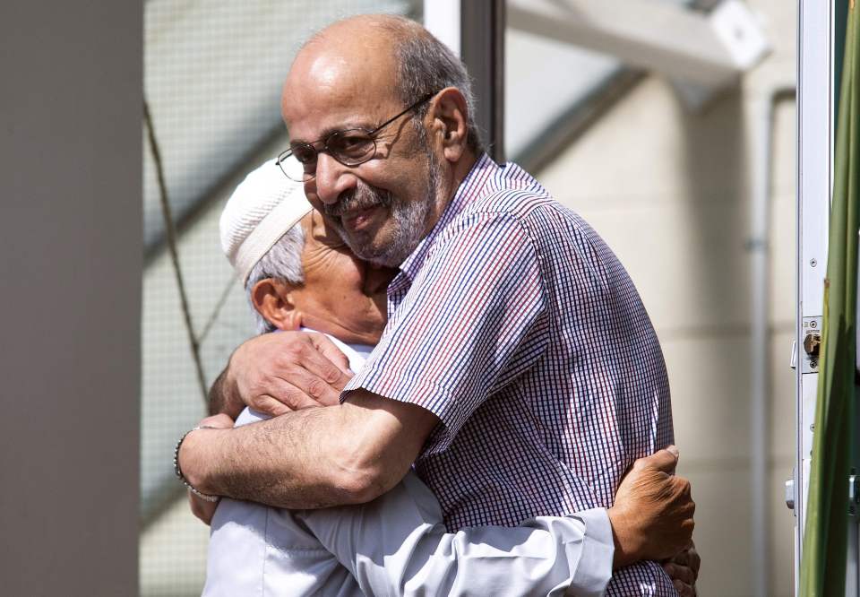  A resident gives a supportive hug to a member of the Muslim community, a week after the Christchurch twin mosques massacre