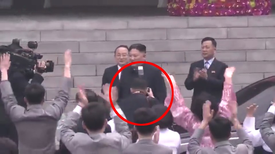  This is the moment the snapper obscured crowds' views of the North Korean leader