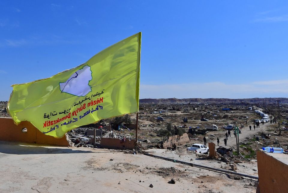  A SDF flag is hoisted over a building above the liberated stretch of land