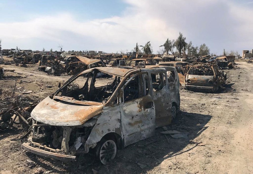  Burned out vehicles and tents are all that remain of the small stretch of land next to the Euphrates River