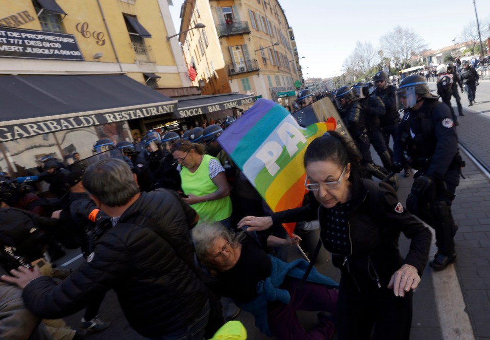  The is the moment the silver-haired protester is battered during clashes with police