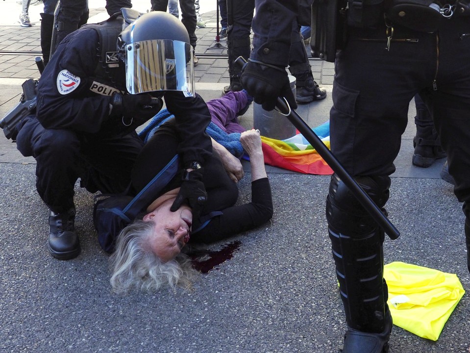  A protester lies bloodied on the ground after more clashes between cops and 'yellow vest' campaigners in France yesterday