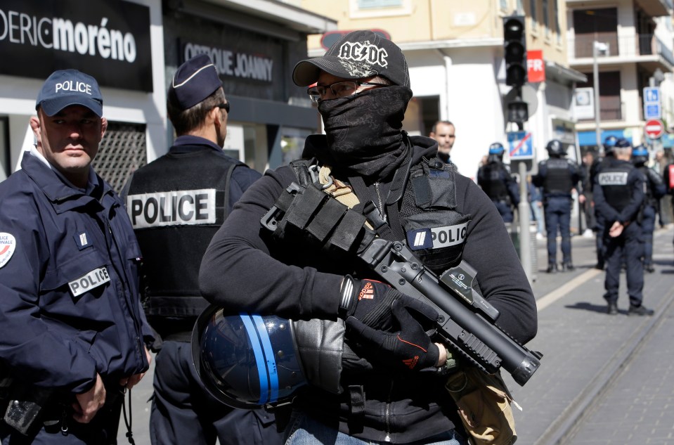  A masked police officer stands guard in Nice