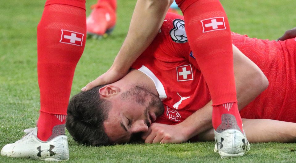  Both players and medics rushed to help Switzerland centre-back Fabian Schar after he smashed heads with Georgia defender Jemal Tabidze in Saturday's tie