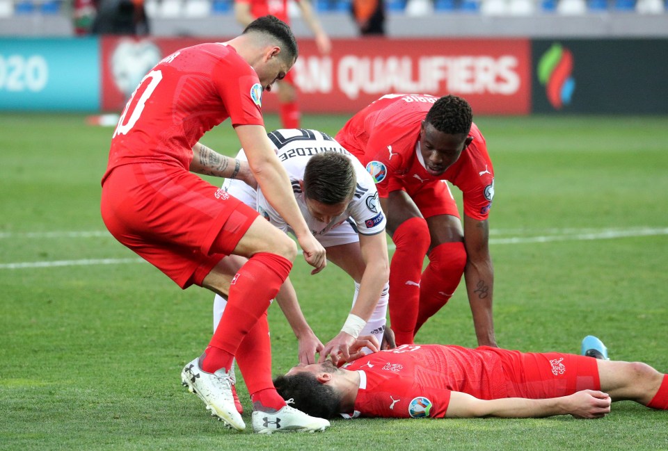 Players rushed to tend to Fabian Schar as he lay unconscious on the pitch