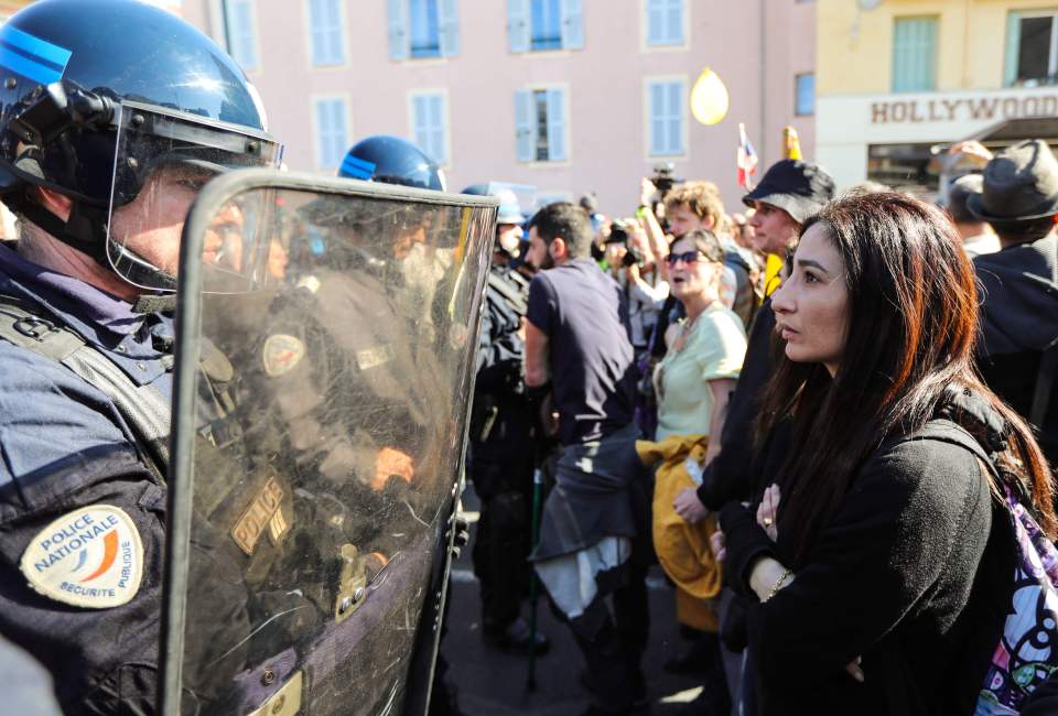  Protesters face down cops armed with riot shields