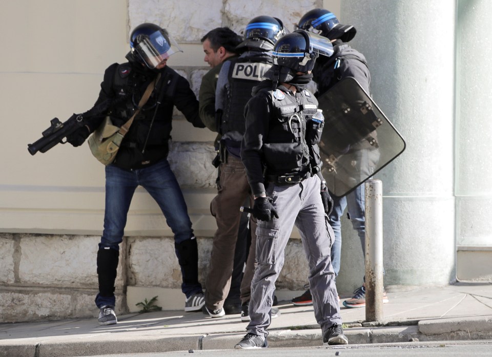  Cops armed with tear gas take aim at protesters as a man is detained