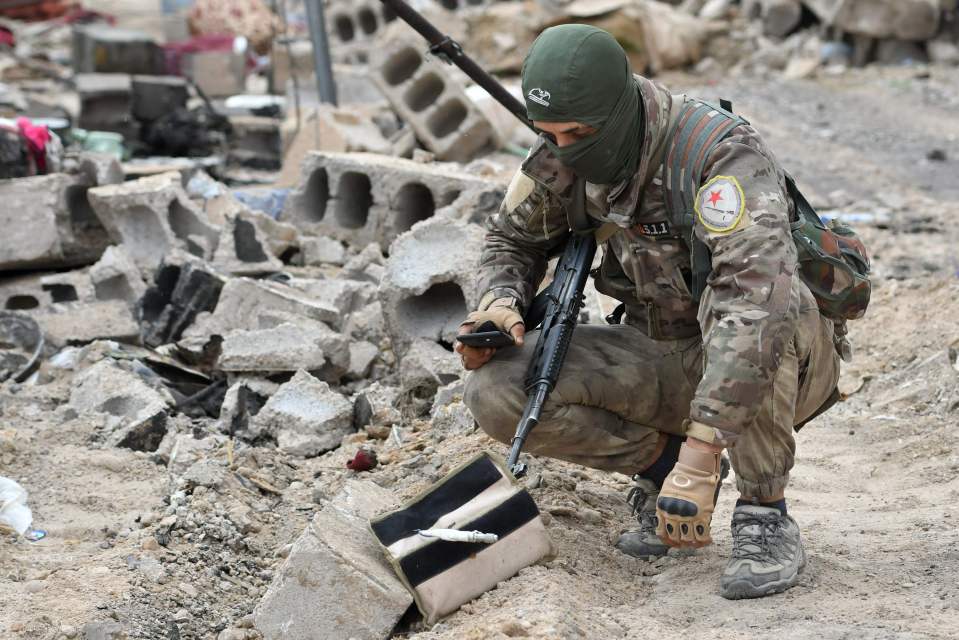  An SDF fighting beside a suicide vest left behind by ISIS in Baghouz